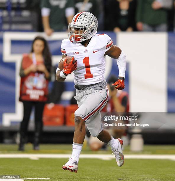 Running back Dontre Wilson of the Ohio State Buckeyes runs the football during a game against the Michigan State Spartans at Lucas Oil Stadium in...