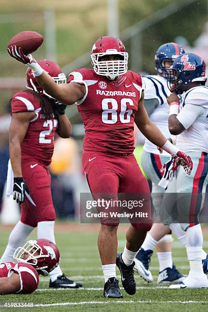 Trey Flowers of the Arkansas Razorbacks come up with a fumble during a game against the Ole Miss Rebels at Razorback Stadium on November 22, 2014 in...