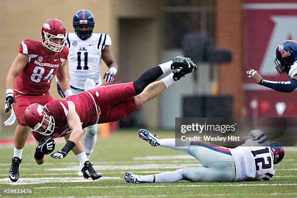 Derby of the Arkansas Razorbacks is tackled in the second quarter by Tony Conner of the Ole Miss Rebels at Razorback Stadium on November 22, 2014 in...