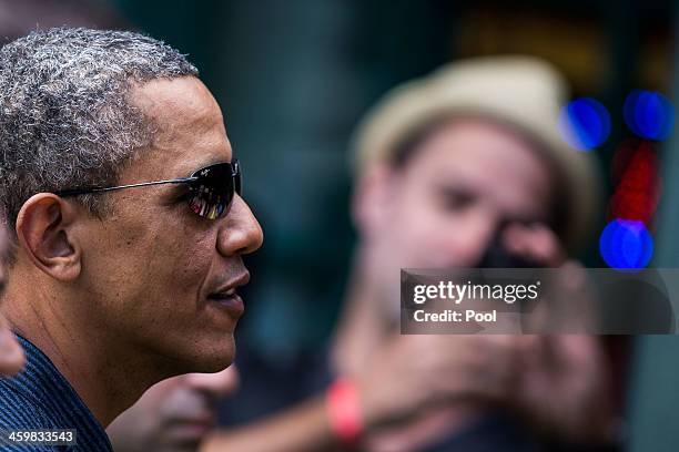 President Barack Obama greets well-wishers outside of Island Snow at Kailua Beach Center on December 31, 2013 in Honolulu, Hawaii. The First Family...