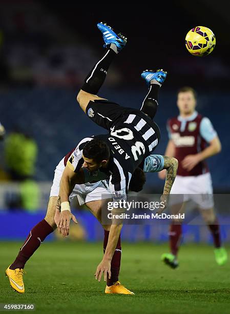 Mehdi Abeid of Newcastle United and Danny Ings of Burnley compete for the ball during the Barclays Premier League match between Burnley and Newcastle...