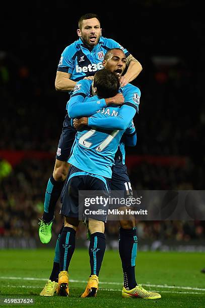 Steven Nzonzi of Stoke City celebrates scoring his team's first goal with his team-mates during the Barclays Premier League match between Manchester...