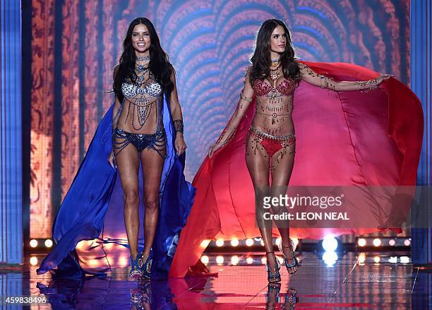 Brazilian models Adriana Lima and Alessandra Ambrosio walk the runway wearing the 2 million US Fantasy bras during the 2014 Victoria's Secret Fashion...