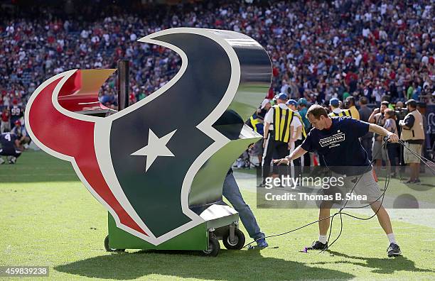 Worker moves the Houston Texans logo before the Houston Texans played the Tennessee Titans in a NFL game on November 30, 2014 at NRG Stadium in...