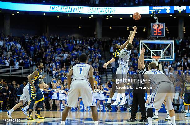 Doug McDermott of the Creighton Bluejays wins the tip off over Chris Otule of the Marquette Golden Eaglesduring their game sat the CenturyLink Center...