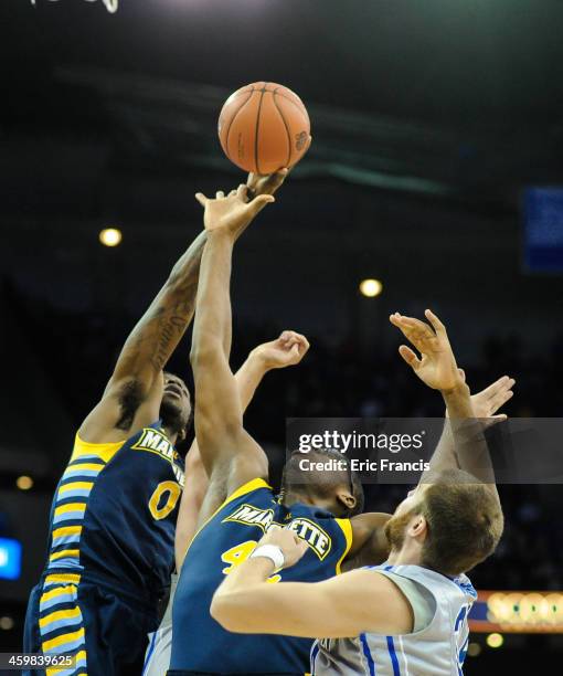 Chris Otule of the Marquette Golden Eagles fights with Ethan Wragge of the Creighton Bluejays during their game at the CenturyLink Center on December...