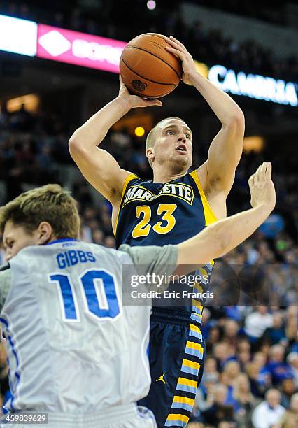 Jake Thomas of the Marquette Golden Eagles shoots over Grant Gibbs of the Creighton Bluejays during their game at the CenturyLink Center on December...