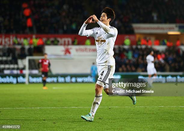 Ki Sung-Yueng of Swansea City celebrates as he scores their first goal during the Barclays Premier League match between Swansea City and Queens Park...