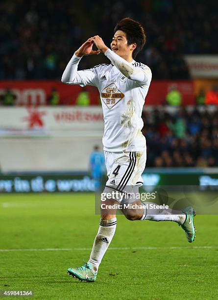 Ki Sung-Yueng of Swansea City celebrates as he scores their first goal during the Barclays Premier League match between Swansea City and Queens Park...