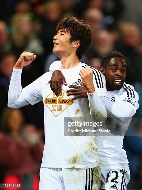 Ki Sung-Yueng of Swansea City celebrates with Nathan Dyer as he scores their first goal during the Barclays Premier League match between Swansea City...