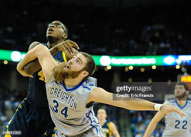 Ethan Wragge of the Creighton Bluejays fight for position with Chris Otule of the Marquette Golden Eagles during their game at the CenturyLink Center...