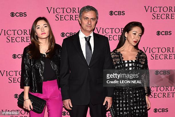 Chelsea's Portuguese manager Jose Mourinho, his wife Matilde Faria and daughter Matilde pose for pictures on the pink carpet for the 2014 Victoria's...
