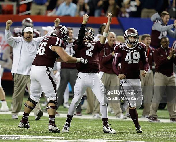 Quarterback Johnny Manziel of the Texas A&M Aggies celebrates with teammates Mike Matthews and Josh Lambo after a touchdown during the Chick-fil-A...