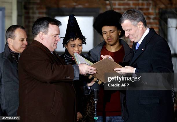 Bill de Blasio, right, is sworn in as the mayor of New York City while his wife Chirlane McCray holds the bible at the start of the new year,...