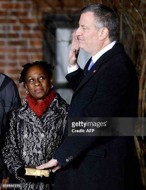 Bill de Blasio, right, is sworn in as the mayor of New York City while his wife Chirlane McCray holds the bible at the start of the new year,...