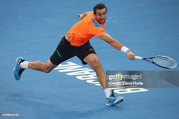 Marin Cilic of Croatia plays a backhand in his match against Grigor Dimitrov of Bulgaria during day four of the 2014 Brisbane International at...