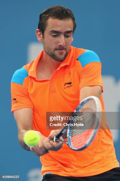 Marin Cilic of Croatia plays a backhand in his match against Grigor Dimitrov of Bulgaria during day four of the 2014 Brisbane International at...