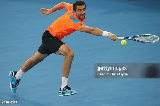 Marin Cilic of Croatia plays a backhand in his match against Grigor Dimitrov of Bulgaria during day four of the 2014 Brisbane International at...