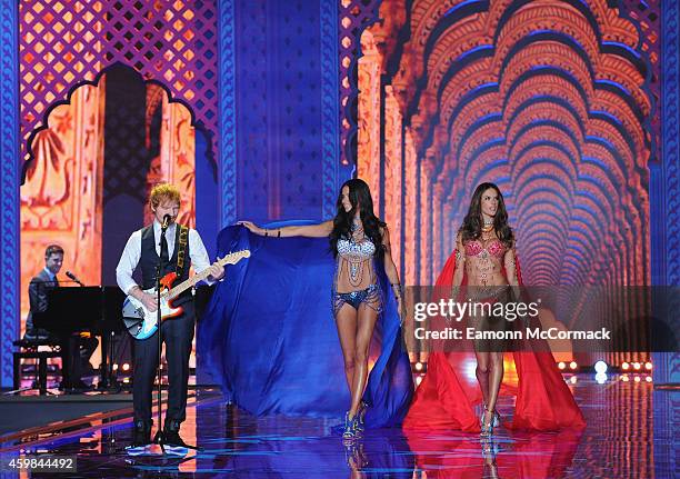 Ed Sheeran performs as models walk the runway at the annual Victoria's Secret fashion show at Earls Court on December 2, 2014 in London, England.