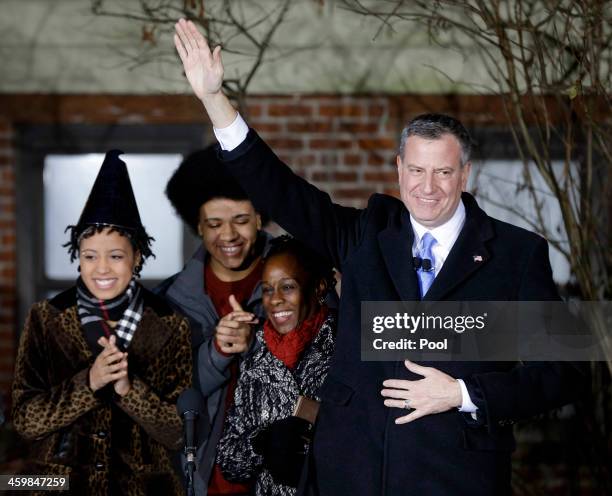 Bill de Blasio waves whilst standing with his family Chiara de Blasio, Dante de Blasio and wife Chirlane McCray after being sworn in as mayor of New...