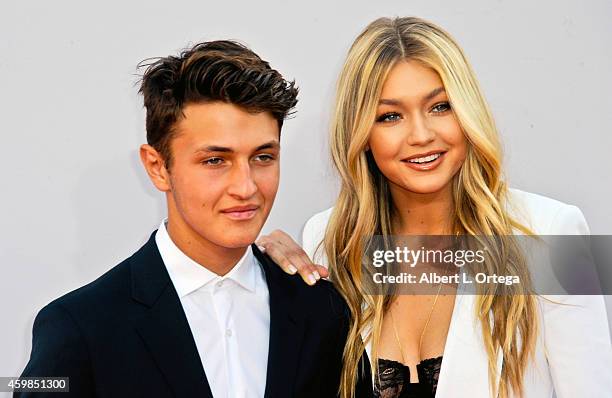 Model Gigi Hadid and brother Anwar Hadid arrive for the 42nd Annual American Music Awards held at Nokia Theatre L.A. Live on November 23, 2014 in Los...