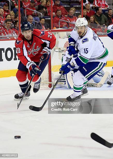 Troy Brouwer of the Washington Capitals and Brad Richardson of the Vancouver Canucks go after the puck during the first period of the Canucks 4-3 win...