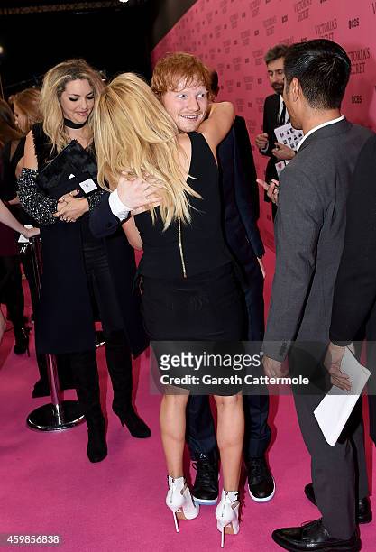 Ellie Goulding hugs Ed Sheeran as they attend the Pre-Cocktail Reception prior the 2014 Victoria's Secret Fashion Show on December 2, 2014 in London,...