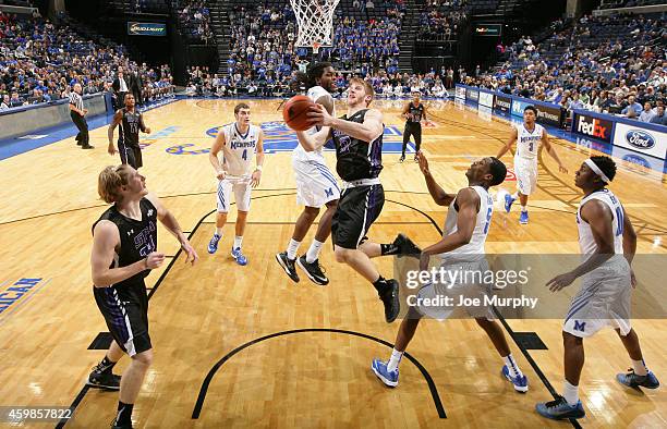 Thomas Walkup of the Stephen F. Austin Lumberjacks drives to the basket for a layup against Shaq Goodwin of the Memphis Tigers on December 2, 2014 at...