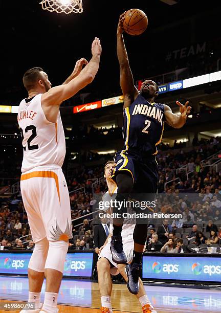 Rodney Stuckey of the Indiana Pacers lays up a shot over Miles Plumlee of the Phoenix Suns during the second half of the NBA game at US Airways...