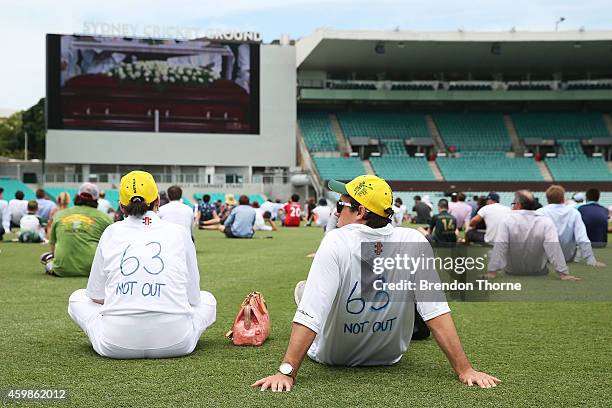 People gather to watch the funeral service held in Macksville for Australian cricketer Phillip Hughes at the Sydney Cricket Ground on December 3,...