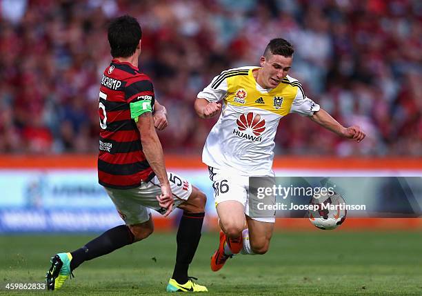 Michael Beauchamp of the Wanderers tackles Louis Fenton of the Phoenix during the round 13 A-League match between the Western Sydney Wanderers and...