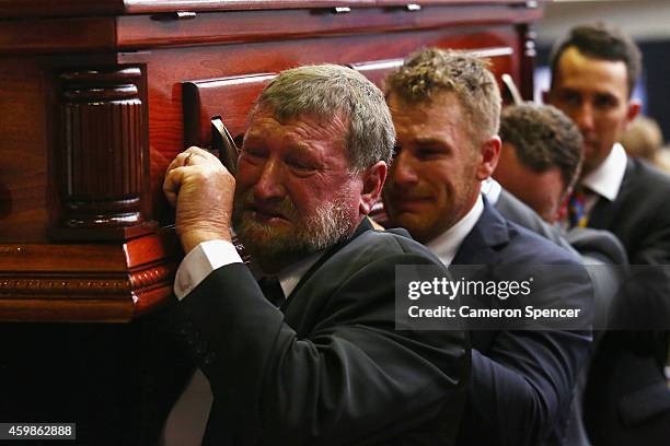 Gregory Hughes, father of Phillip Hughes carries the coffin of his son Phillip Hughes during the Funeral Service for Phillip Hughes at Macksville...