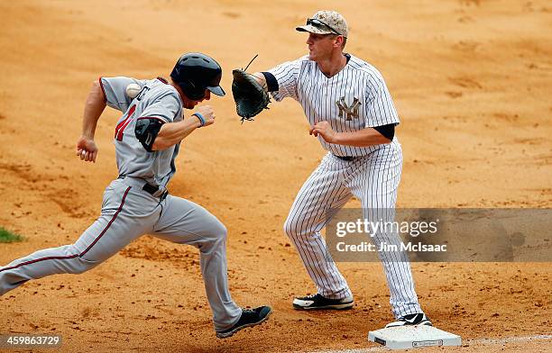 Clete Thomas of the Minnesota Twins reaches first base as Lyle Overbay of the New York Yankees can't come up with the ball during the eighth inning...