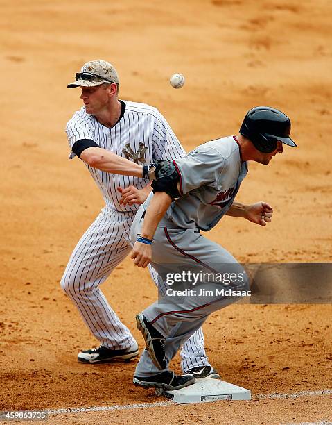 Clete Thomas of the Minnesota Twins reaches first base as Lyle Overbay of the New York Yankees can't come up with the ball during the eighth inning...