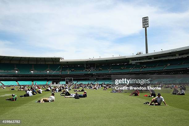 People gather to watch the funeral service held in Macksville for Australian cricketer Phillip Hughes at the Sydney Cricket Ground on December 3,...