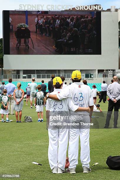 People gather to watch the funeral service held in Macksville for Australian cricketer Phillip Hughes at the Sydney Cricket Ground on December 3,...