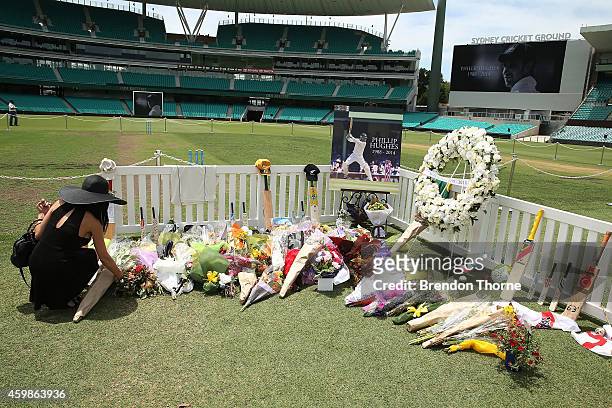 People lay flowers at the Randwick End of the SCG prior to the gathering of people to watch the funeral service held in Macksville for Australian...