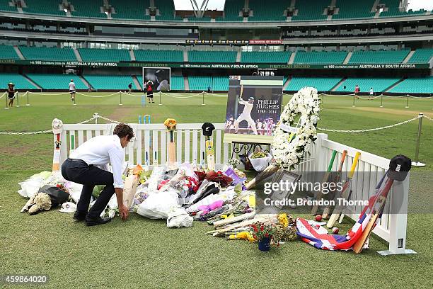 People lay flowers at the Randwick End of the SCG prior to the gathering of people to watch the funeral service held in Macksville for Australian...
