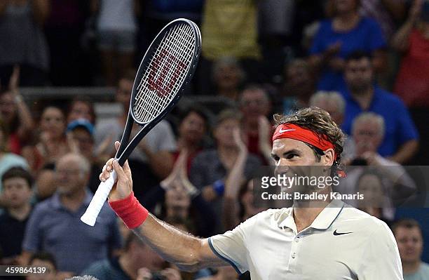 Roger Federer of Switzerland celebrates victory as he waves to fans after his match against Jarkko Nieminen of Finland during day four of the 2014...