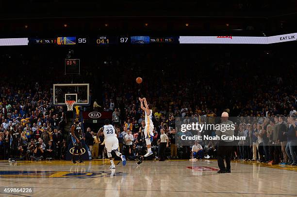 Stephen Curry of Golden State Warriors takes a shot as time runs down against the Orlando Magic on December 2, 2014 at Oracle Arena in Oakland,...