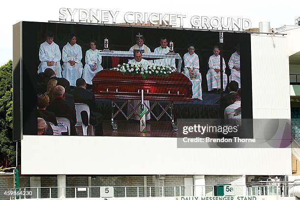 People gather to watch the funeral service held in Macksville for Australian cricketer Phillip Hughes at the Sydney Cricket Ground on December 3,...