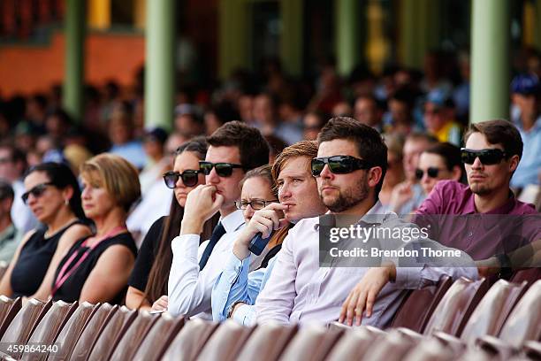 People gather to watch the funeral service held in Macksville for Australian cricketer Phillip Hughes at the Sydney Cricket Ground on December 3,...