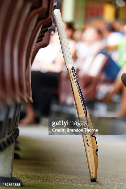 Cricket bat stands in the members stand of the SCG as people gather to watch the funeral service held in Macksville for Australian cricketer Phillip...