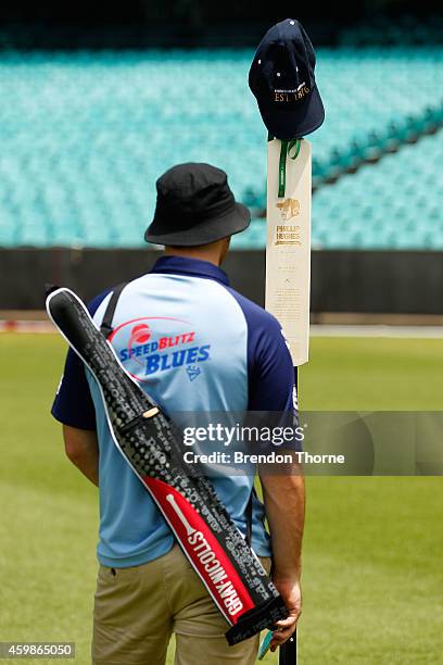 Mourners pay their respects as people gather to watch the funeral service held in Macksville for Australian cricketer Phillip Hughes at the Sydney...