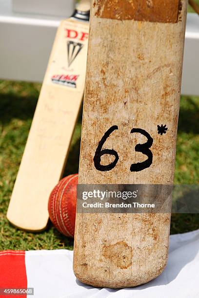 Cricket bat with 63 not out, in rememberance of Phillip Hughes' final unbeaten innings stands at the Randwick End of the SCG as mourners pay their...