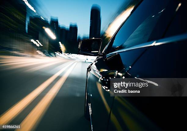 driving fast in the city at night - toned image stock pictures, royalty-free photos & images