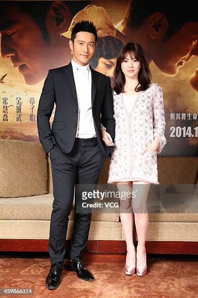 Actress Song Hye-gyo and actor Huang Xiaoming take photo shoots during their promotion new film "The Crossing" on December 2, 2014 in Taipei, Taiwan...