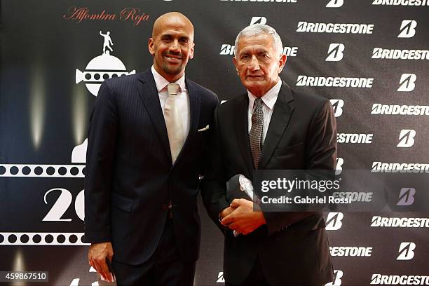 Juan Sebastian Veron President of Estudiates and his father Juan Ramon Veron former player of Estudiantes pose for pictures on the red carpet before...