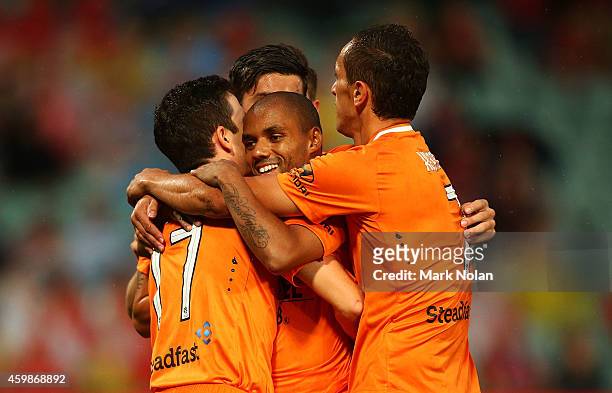 Henrique of the Roar celebrates with team mates after scoring a goal during the round four A-League match between the Western Sydney Wanderers and...