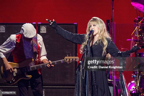 Vocalist Stevie Nicks and bassist John McVie of Fleetwood Mac perform on stage at Viejas Arena on December 2, 2014 in San Diego, California.